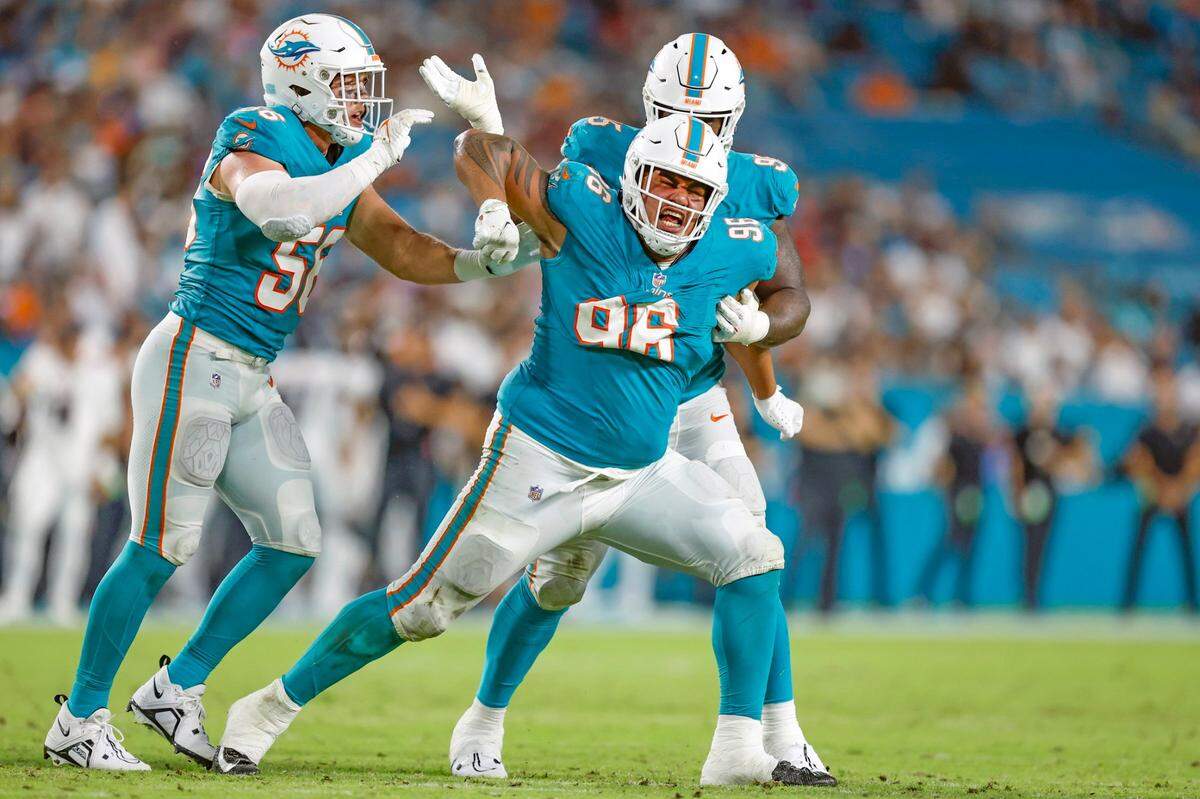 Miami Dolphins defensive tackle Brandon Pili (96) reacts as tackling Atlanta Falcons running back Godwin Igwebuike (42) in the fourth quarter. Joining is the celebration is linebacker Garrett Nelson (56) and defensive tackle Josiah Bronson (95).