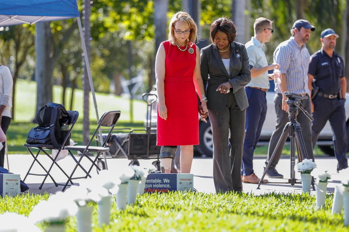 Representative Val Demings walks with former Congresswoman Gabrielle Giffords around the Gun Violence Memorial Installation by Giffords at Bayfront Park in downtown Miami on Monday, Dec. 13, 2021. The memorial features 3,000 vases for dedicated to Floridians who died from gun violence last year.