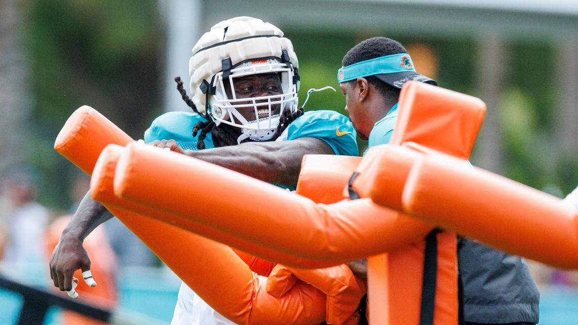 Miami Dolphins outside linebackers coach Ty McKenzie works with Dolphins linebacker Melvin Ingram (6) during NFL football training camp at Baptist Health Training Complex in Hard Rock Stadium on Sunday, August 7, 2022 in Miami Gardens, Florida.