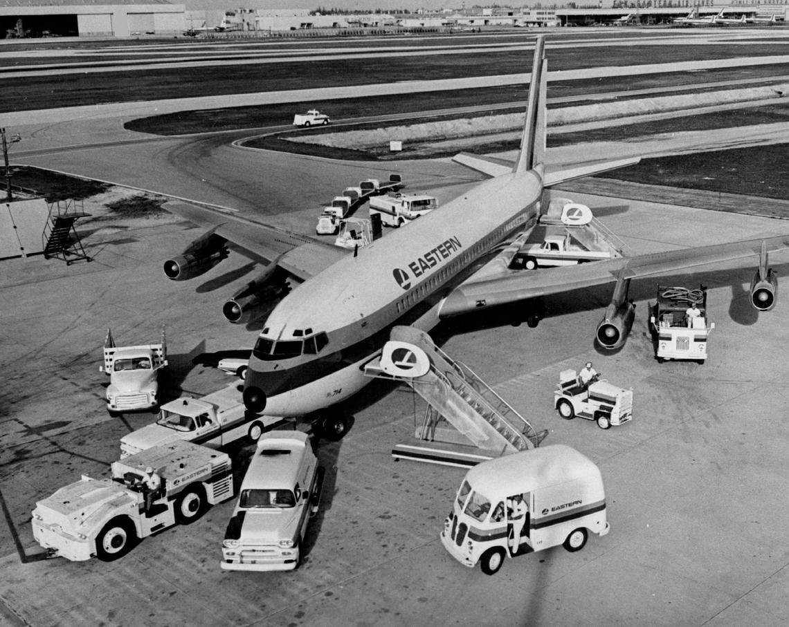 Ground workers converge on an Eastern Airlines jet at MIA in 1966.