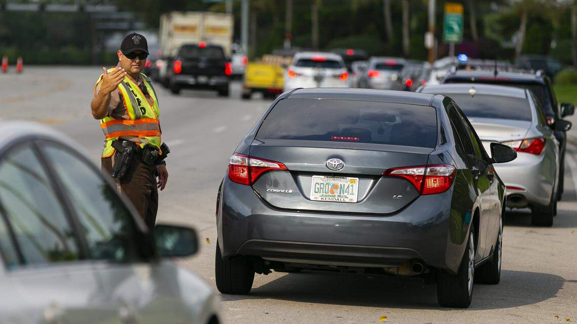 Police direct traffic near the Hard Rock Stadium in Miami Gardens, Florida, on Monday, April 13, 2020.