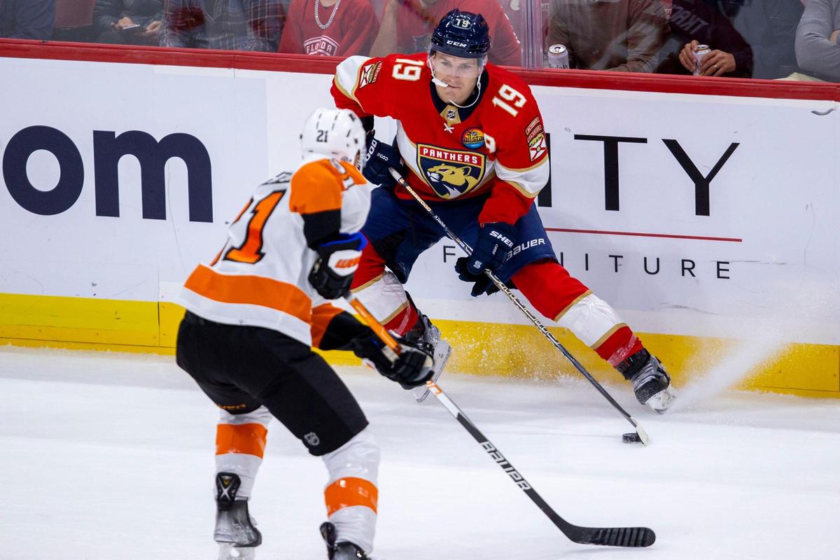 Florida Panthers left wing Matthew Tkachuk (19) looks to pass while guarded by Philadelphia Flyers left wing Scott Laughton (21) during the first period of an NHL game at FLA Live Arena in Sunrise, Florida, on Wednesday, October 19, 2022.