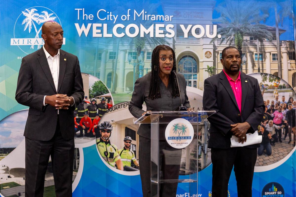 Miramar Vice Mayor Alexandra P. Davis, center, stands alongside Mayor Wayne M. Messam, left, and Commissioner Maxwell B. Chambers, right, as she addresses the media during a press conference regarding the proposition of a new trash incinerator being installed near the county line by Miami-Dade County, on Wednesday, Aug. 28, 2024, in Miramar, Florida.