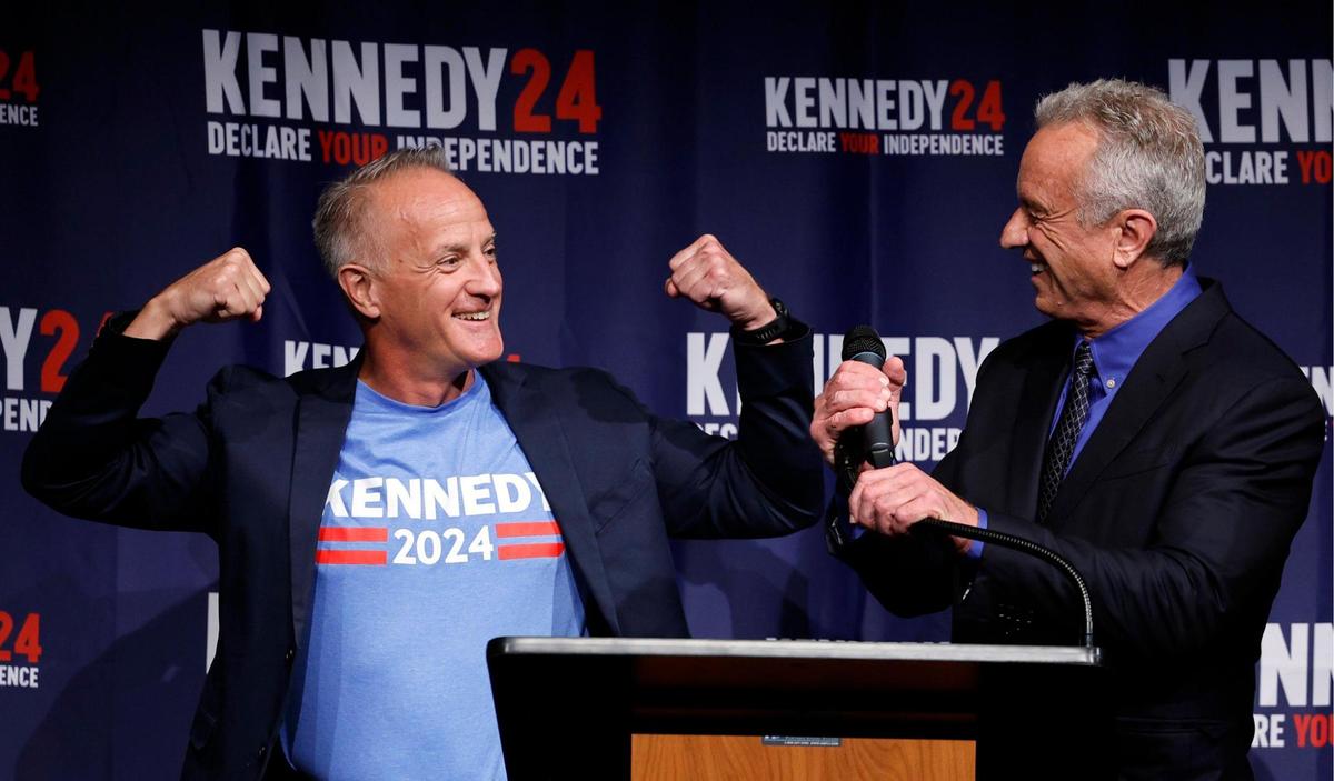 Miami Beach City Commissioner Ricky Arriola, at left, flexes as he tells the crowd how fit Robert F. Kennedy Jr. is as he approaches the podium. Kennedy Jr. hit the campaign trail to celebrate his launch of an independent run for President of the United States of America while visiting the Adrienne Arsht Center for the Performing Arts in Miami on Thursday, October 12, 2023.
