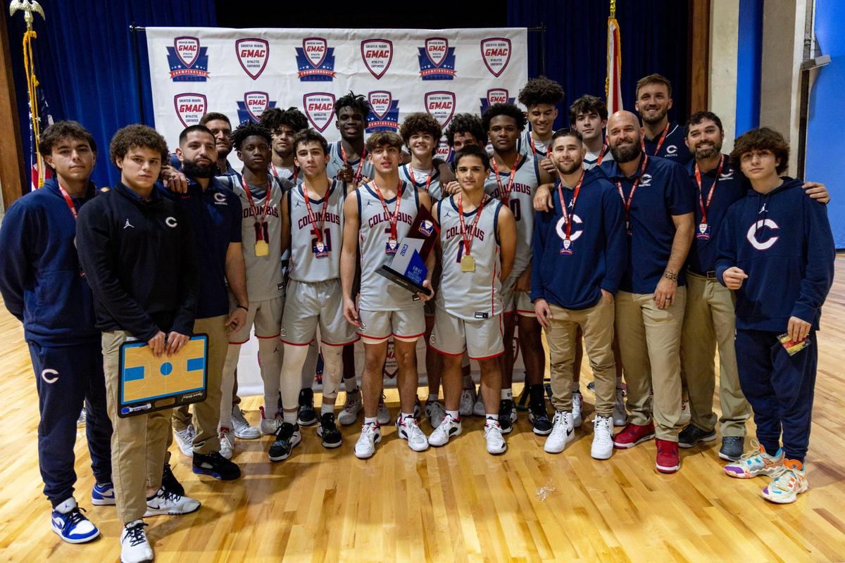 Christopher Columbus High School players and coaches pose with the first place trophy after defeating Miami Palmetto Senior High School 84-57 during the boys’ GMAC Basketball Finals at Miami-Dade College Kendall campus Gibson Gymnasium in Miami, Florida, on Friday, January 27, 2023.