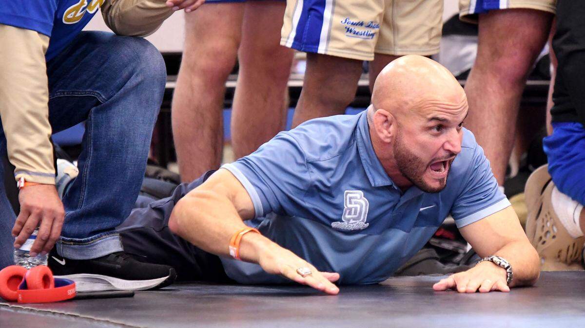 South Dade head coach Victor Balmeceda stirs his team on to victory during the Class 3A state championship duel at the FHSAA Duals on Saturday at Osceola High School in Kissimmee.