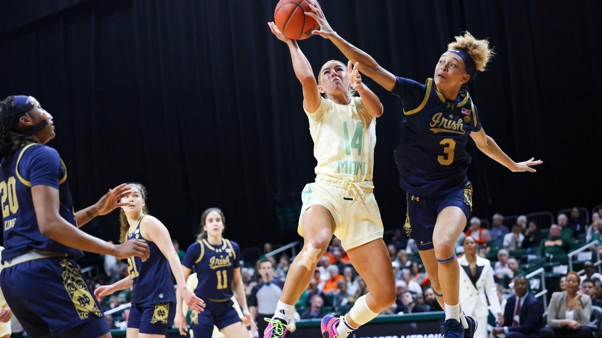 Miami Hurricanes guard Haley Cavinder (14) attempts to shoot while Notre Dame Fighting Irish guard Hannah Hidalgo (3) blocks it during the first period of a game on Thursday, Feb. 20, 2025, at Watsco Center in Coral Gables, Fla.