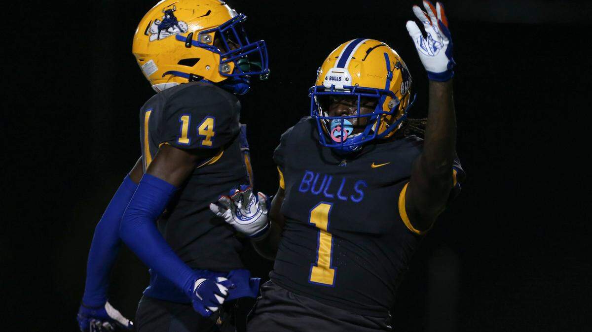 Northwestern Bulls Adam Moore (1) celebrates with wide receiver Calvin Russell (14) after scoring a touchdown during the third quarter against the Jackson Generals of a high school football game at Traz Powell Stadium in Miami, Florida, on Friday, September 1, 2022.