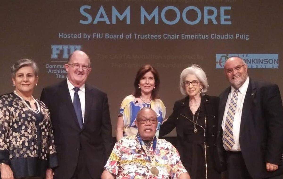 Music legend Sam Moore (front center) was honored as the inaugural recipient of the CARTA Medallion from the FIU College of Communication, Architecture + The Arts and the Tonkinson Foundation. The ceremony was at the Herbert and Nicole Wertheim School of Music & Performing Arts at Florida International University on May 19, 2022. Pictured: Margarita Tonkinson, left, with Rick Tonkinson, a member of the board of directors of the FIU Foundation and president of the Tonkinson Foundation, Claudia Puig, center back, FIU Board of Trustees chair emeritus, Joyce Moore, Brian Schriner, right, dean of the FIU College of Communication, Architecture + The Arts, Sam Moore, front center.