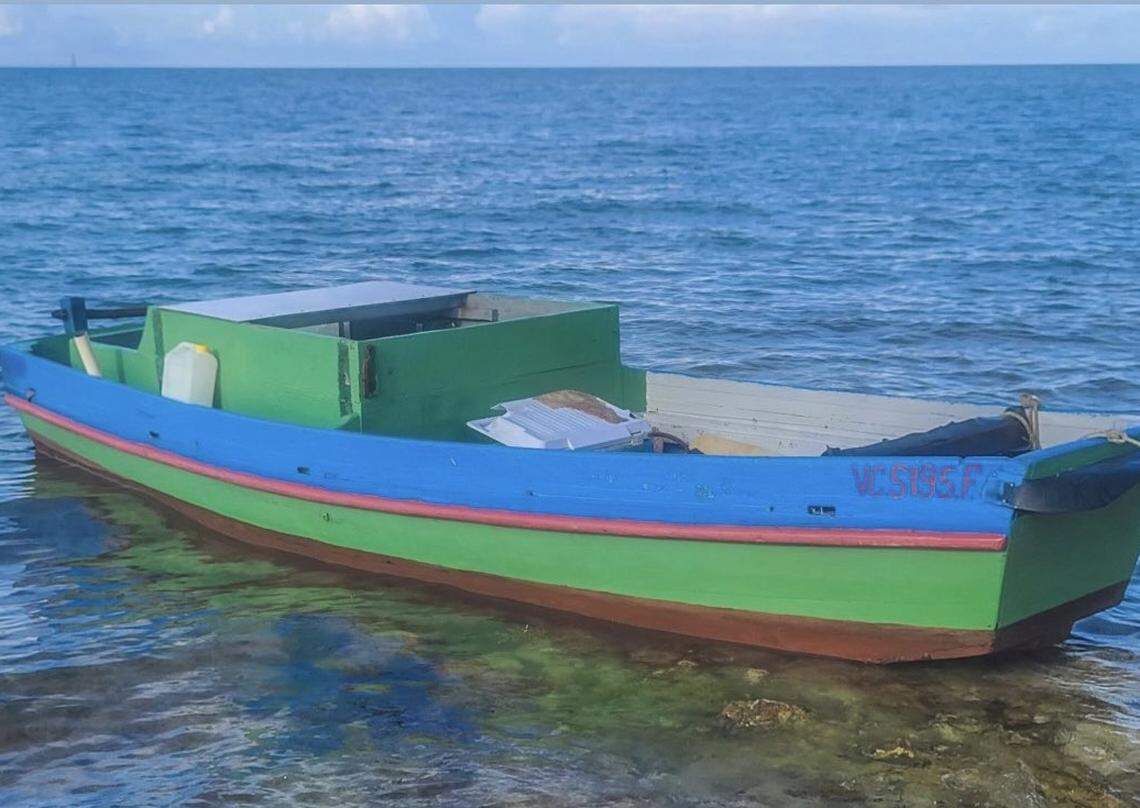 A wooden green boat floats in shallow water near Sombrero Beach in the Middle Florida Keys city of Marathon on Sunday, June 13, 2021. Four people from Cuba arrived in the Keys on the vessel earlier that day.