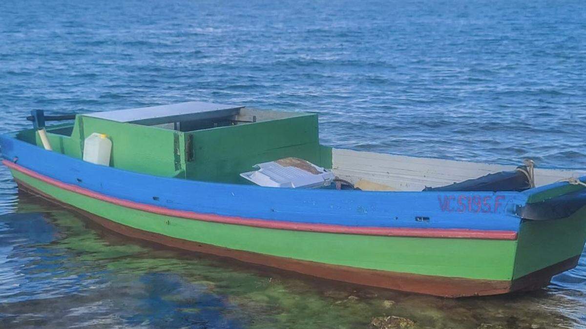 A wooden green boat floats in shallow water near Sombrero Beach in the Middle Florida Keys city of Marathon on Sunday, June 13, 2021. Four people from Cuba arrived in the Keys on the vessel earlier that day.