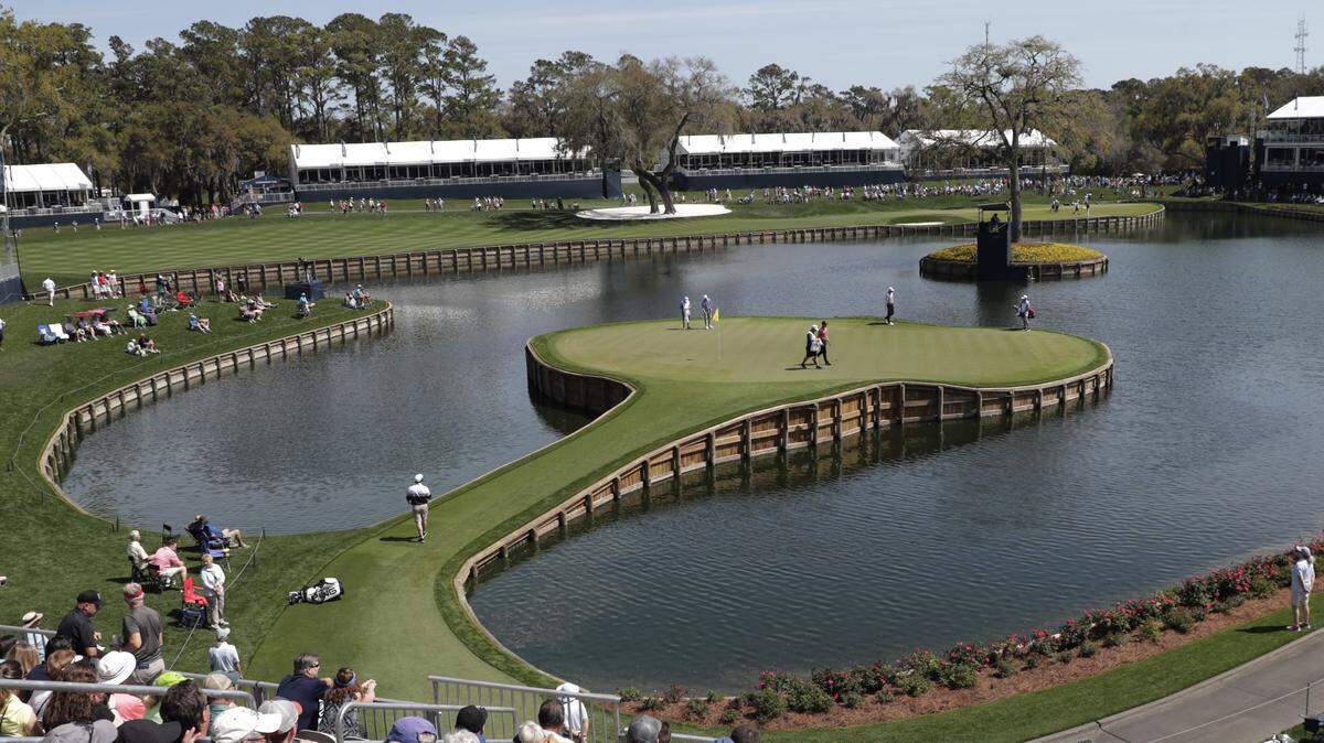 Cameron Champ, Nate Lashley, Kevin Tway and their caddies, walk the 17th green, during the first round of The Players Championship golf tournament Thursday, March 12, 2020 in Ponte Vedra Beach, Fla.