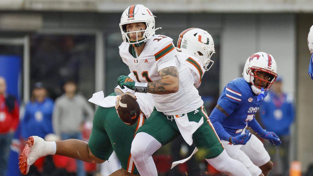 Miami Hurricanes quarterback Carson Beck (11) scrables out of the pocket during an NCAA football game against the Southern Methodist University Mustangs in the first half at Gerald Ford Stadium on Saturday, November 1, 2025, in Dallas, Texas.