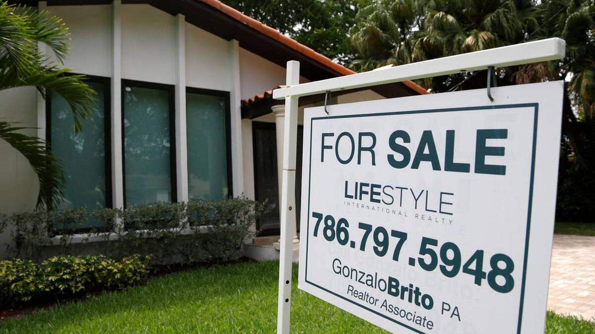 A for sale sign outside a home in Miami-Dade.