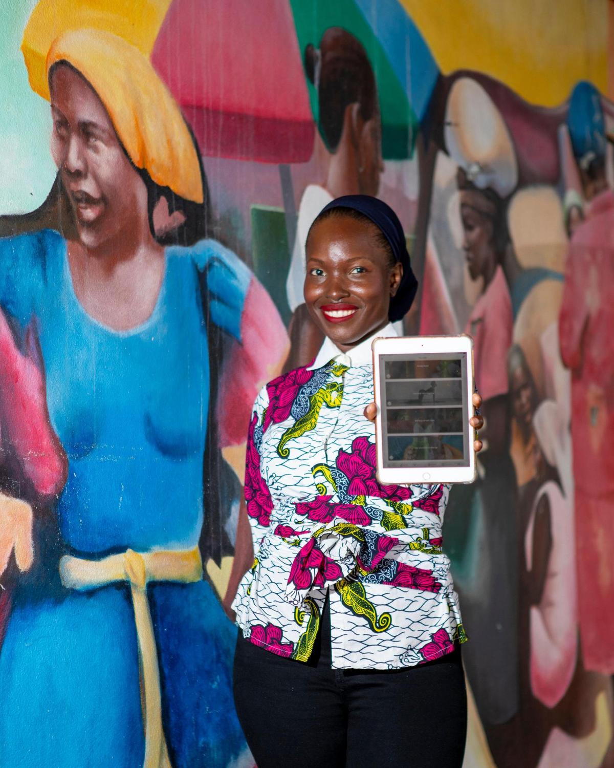 Entrepreneur Nzingah Oniwosan shows off her self-care application, 365Zing, which helps users become healthier through meal plans, yoga classes and therapy, at the Little Haiti Cultural Center in the Little Haiti neighborhood of Miami, Florida, on Friday, August 13, 2021. Oniwosan was one of thousands of Black Americans who started new businesses in 2020, a year that saw more Black entrepreneurial growth than at any time in the last 25 years, according to the Kauffman Foundation’s annual report.