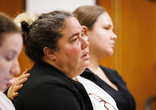 Gamaly Hollis left is comforted by Kelsey Brattin, an assistant public defender, during a September 2024 hearing.