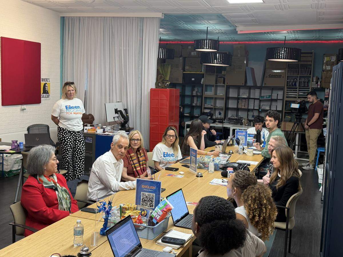 A table with laptops, volunteers and politicians Rahm Emanuel, Daniella Levine Cava and Eileen Higgins. 