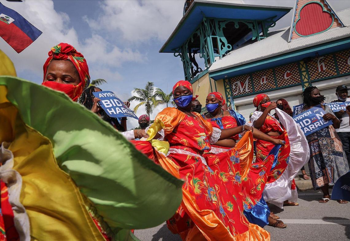 Nancy St. Leger, left, and her NSL Danse Ensemble spill their performance into NE 2nd Avenue outside the Little Haiti Cultural Complex’s Caribbean Marketplace as Haitian American supporters of Democratic presidential nominee Joe Biden lined the streets of Northeast Second Avenue in Little Haiti hoping to catch a glimpse of the visit of the candidate as he arrived at the Little Haiti Cultural Center on Monday, October 5, 2020.