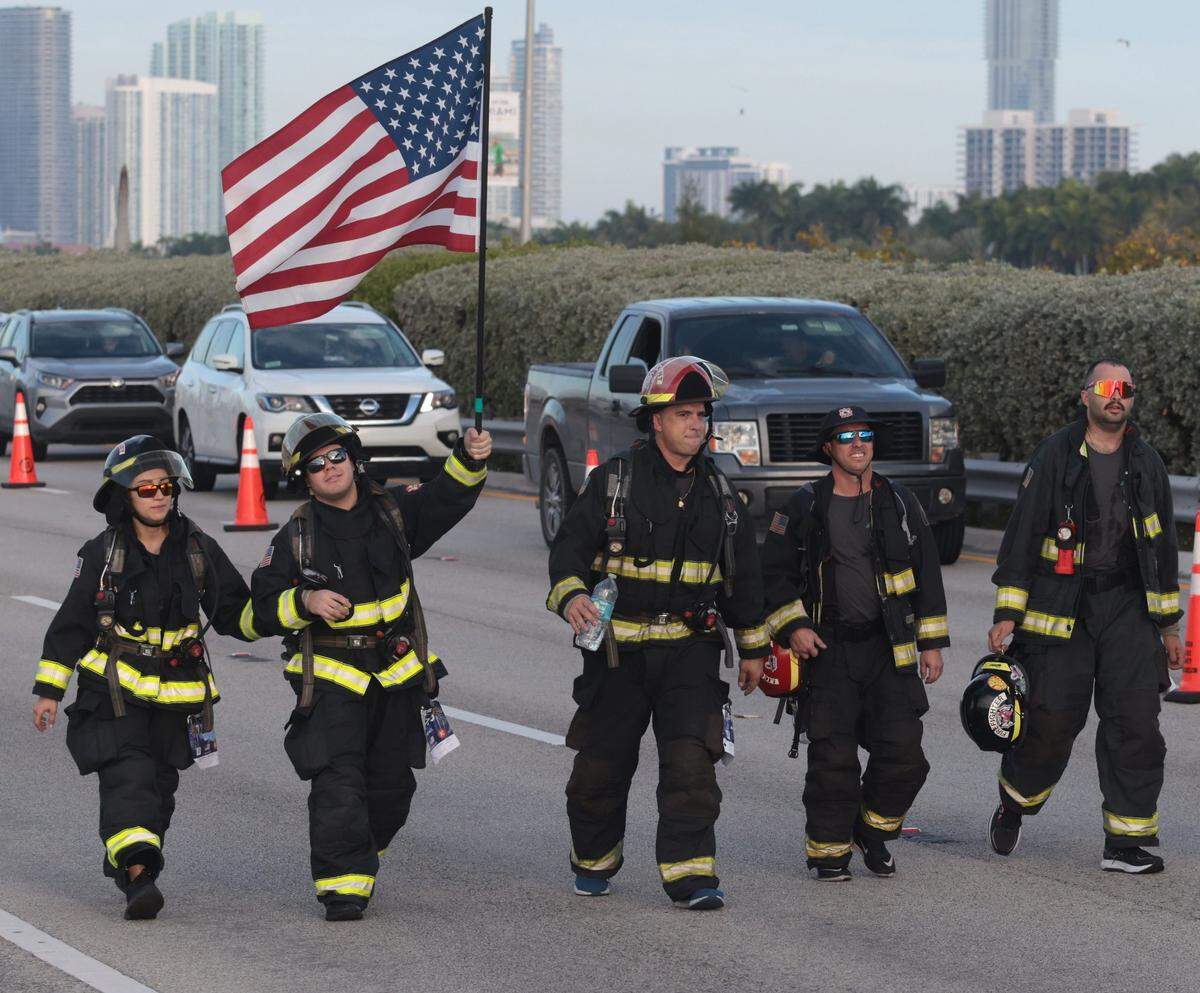 City of Miami and local department firefighters participate in the Miami Marathon while making their way east on the MacArthur Causeway as they participate in the 20th annual Life Time Miami Marathon and Half Marathon on Sunday, February 6, 2022. There were more than 15,000 combined runners registered for the marathon and half marathon.