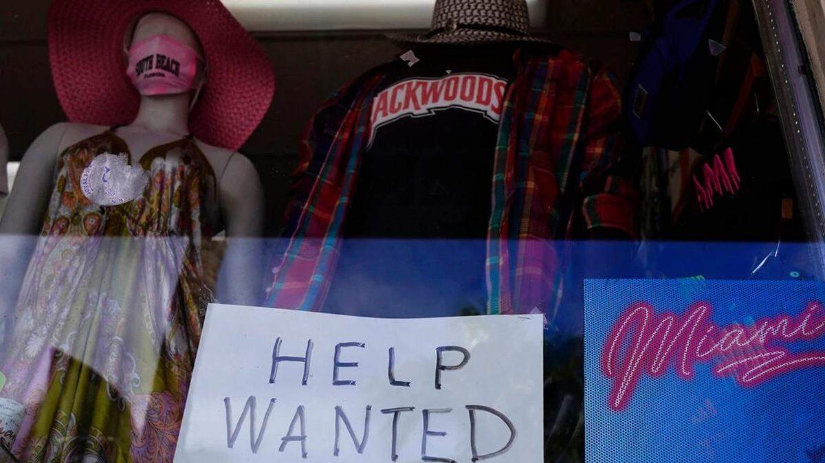 A “Help Wanted,” sign sits in the window of a Miami Beach souvenir shop. Employers are struggling to find workers as the economy recovers from the coronavirus pandemic.