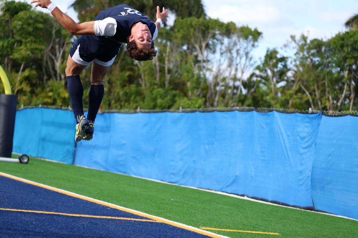 Gulliver’s Jacob Lombard does a back flip after scoring a goal during the Raiders’ 3-0 victory over Cardinal Gibbons on Tuesday in a Region 4-4A quarterfinal boys’ soccer match at Gulliver Prep School.