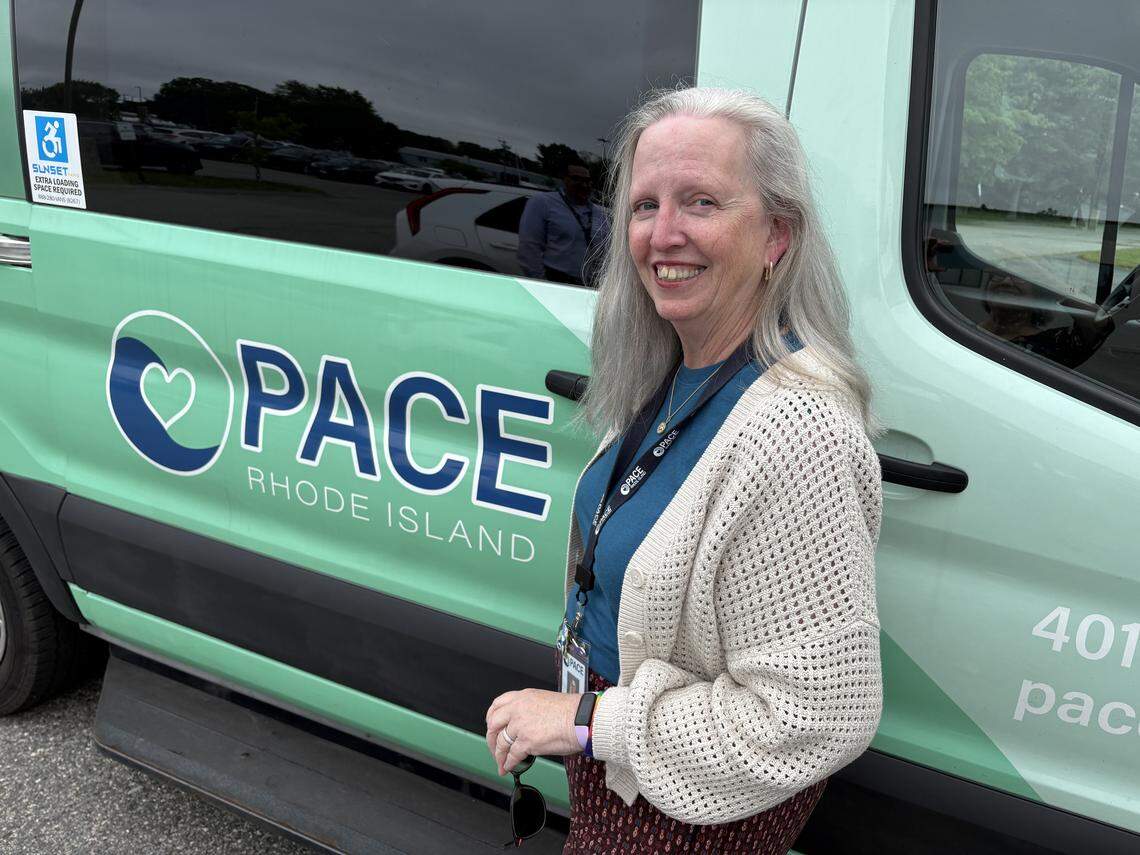 Kriss Auger, social work and behavioral health manager at the PACE Organization of Rhode Island, outside the van used to transport participants to the PACE center in East Providence.