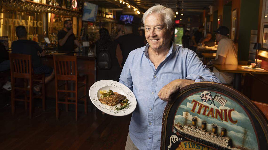 Kevin Rusk, owner of Titanic Brewery & Restaurant in Coral Gables, holds a the Mediterranean zaatar and lemon grilled salmon, one of the specials the restaurant is offering.