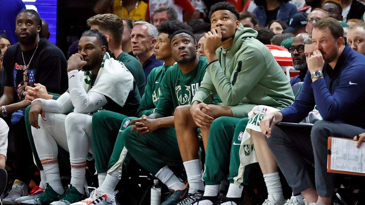 Milwaukee Bucks forward Giannis Antetokounmpo (34), wearing a green hoodie, looks on from the bench during the game against the Miami Heat in Game 3 of the first-round playoff series at Kaseya Center in Miami on Saturday, April 22, 2023.