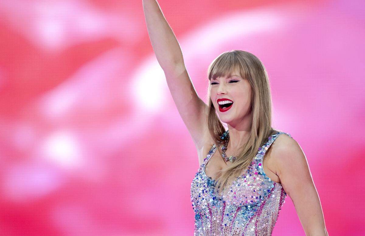 Taylor Swift performing in one of her many bejeweled outfits. 