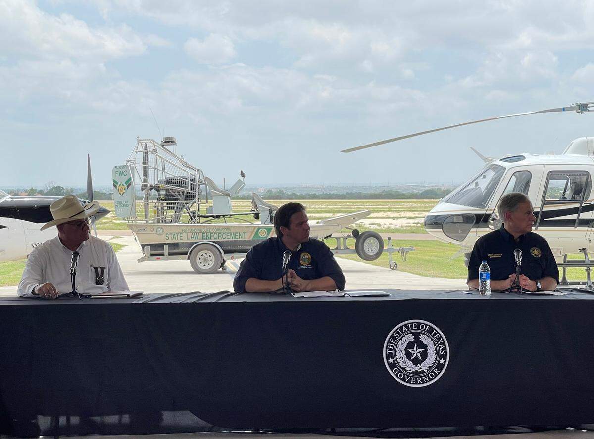 Florida Gov. Ron DeSantis and Texas Gov. Greg Abbott hold a press conference in Del Rio, Texas, in July 2021 to talk about a three-week effort by a contingent of Florida law enforcement officers to help enforce the U.S.-Mexico border.