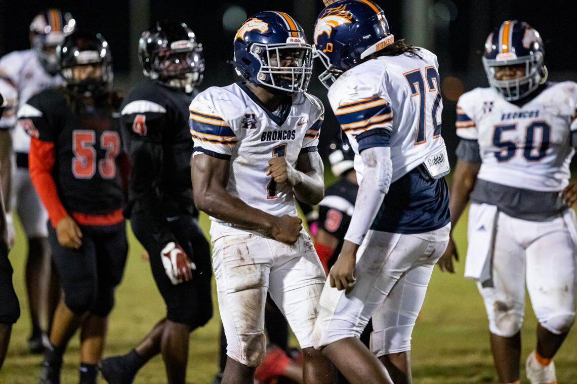Homestead Broncos running back Isaac Brown (1) and offensive lineman Adrian Loatman (72) react after a play against Southridge Spartans during the second quarter of a high school football game at Southridge Park on Friday, Oct. 14, 2022, in Miami, Fla.