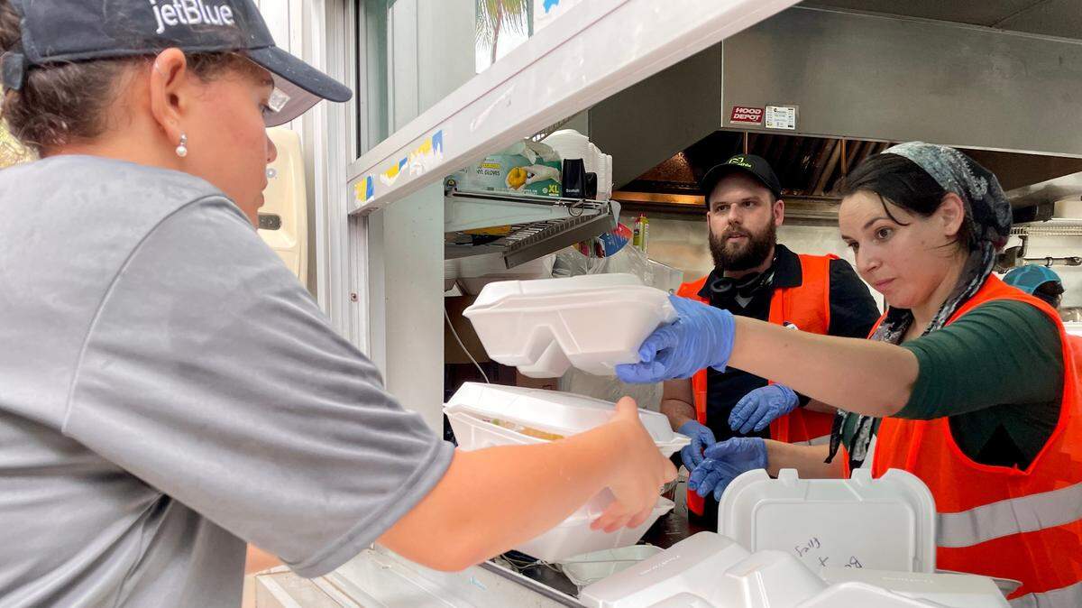 Dina Brookmyer, right, with her husband, Jordan, were visiting from Baltimore when they decided to volunteer at the kosher kitchen at the Surfside Community Center, which has been cooking thousands of meals a day to rescue workers and families of those affected by the Champlain Towers condo collapse.