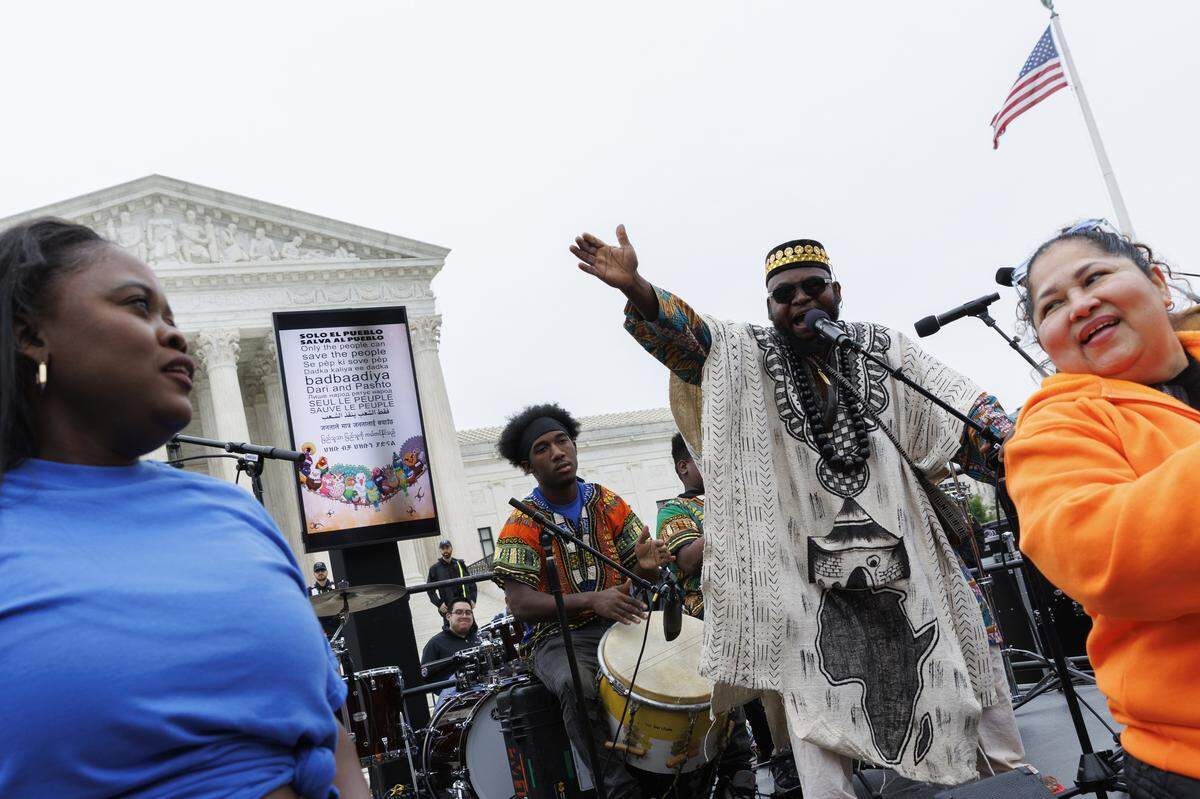 WASHINGTON, DC - APRIL 29: Demonstrators perform a dance during a protest outside U.S. Supreme Court on April 29, 2026 in Washington, DC. The court heard arguments challenging DHS's termination of Temporary Protected Status for asylum seekers. (Photo by Tom Brenner/Getty Images)