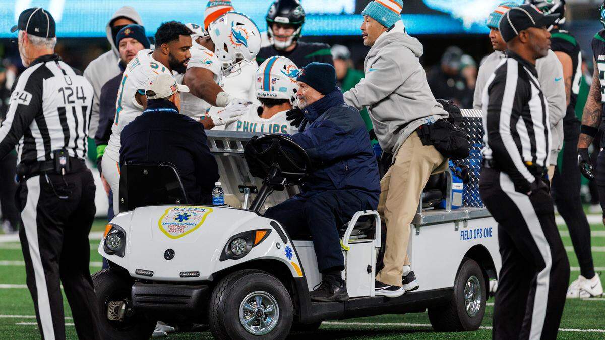Miami Dolphins linebacker Jaelan Phillips (15) is being carteret out after getting injured in a play during fourth quarter of an NFL football game against the New York Jets at MetLife Stadium on Friday, Nov. 24, 2023 in East Rutherford, New Jersey.