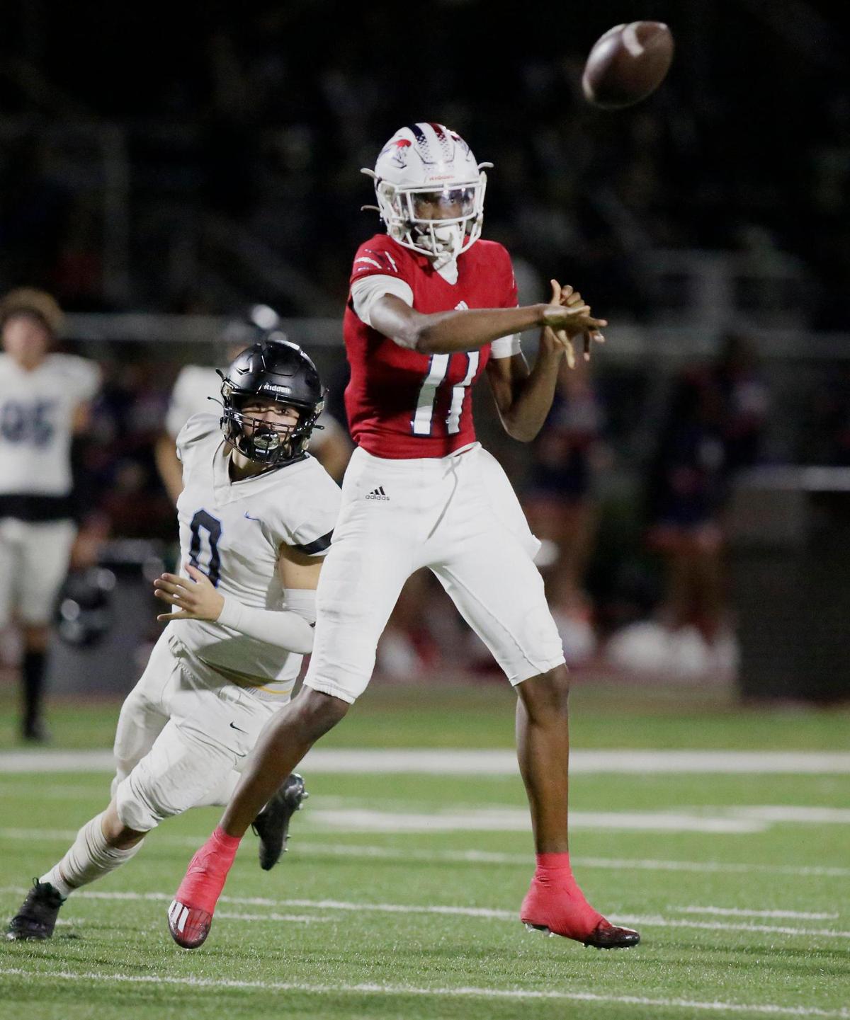 Chaminade-Madonna Lions quarterback Cedrick Bailey (11) throws a pass during the state semifinal football game agains Archbishop Carroll Bulldogs on Friday, December 1, 2023 at Chaminade-Madonna School in Hollywood. Andrew Uloza / for Miami Herald