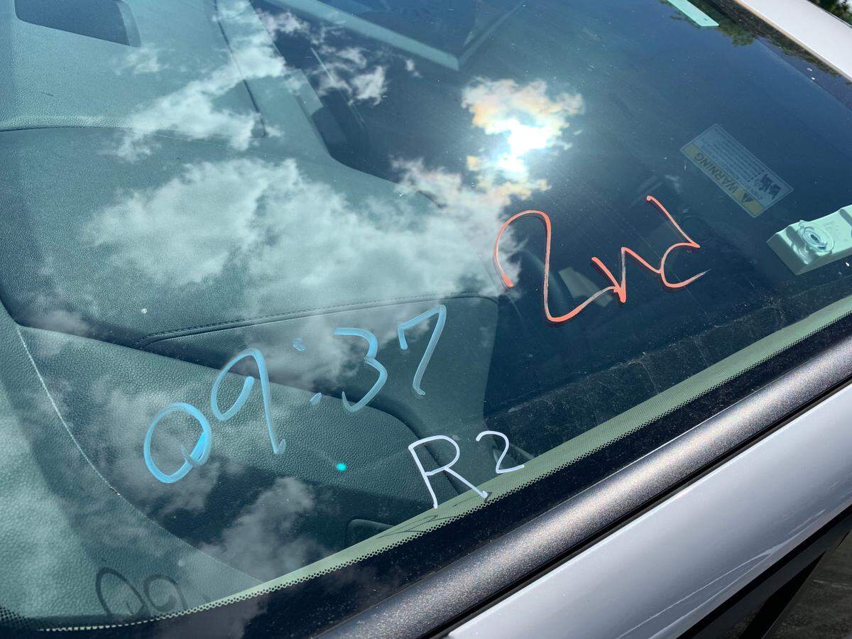 When you get your COVID vaccine at a drive-thru location, such as Marlins Stadium in Miami, you are directed to wait 15 minutes in your car after the injection to make sure there are no reactions. This notation on the car’s window indicates the recipient got a second dose and the time of day.