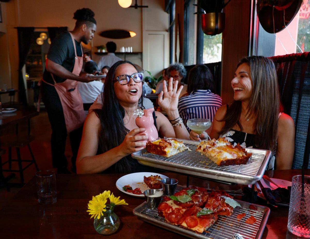 Diners enjoy Detroit-style pizza at Vice City in South Miami, which popped up in Bar Bella during the summer. Now it will stay on permanently. 