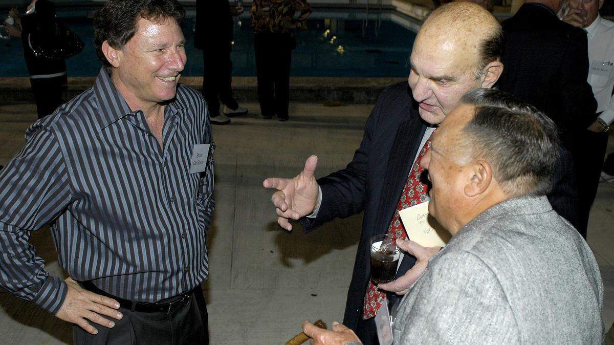 1/26/08-Skip Bertman (center) Director of Athletics at Louisiana State University reminisces with Shelly Dunkel (right) and Bruce Davidson (left) during the Miami Dade College Baseball 45 years of excellence ceremony at the Kendall Campus in Miami.  Chris Cutro/For the Miami Herald.