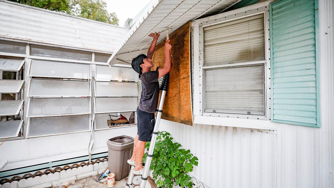 Juan Alonso, 19, boards up his home as he prepares for Hurricane Milton at Fairmont Mobile Home Estates in Ruskin, Florida on Tuesday, October 8, 2024.