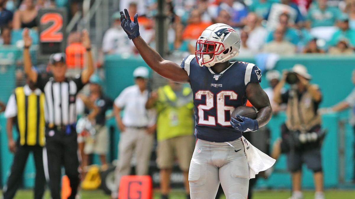 New England Patriots running back Sony Michel (26) reacts after scoring a touchdown during first quarter of an NFL football game against the Miami Dolphins at Hard Rock Stadium on Sunday, September 15 2019, in Miami Gardens.