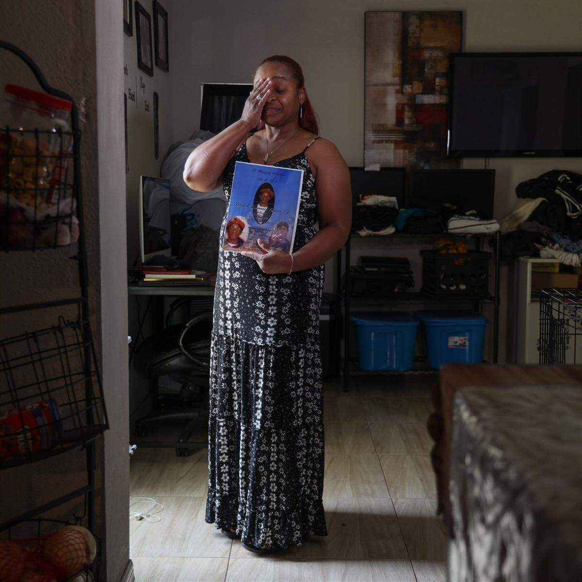 Georgia resident Tangela Johnson, 52, holds Derrick “Termite” Gloster’s funeral program on July 25, 2024, in Miami. She is seeking justice after the State Attorney’s Office gave immunity to the killer in a plea deal.