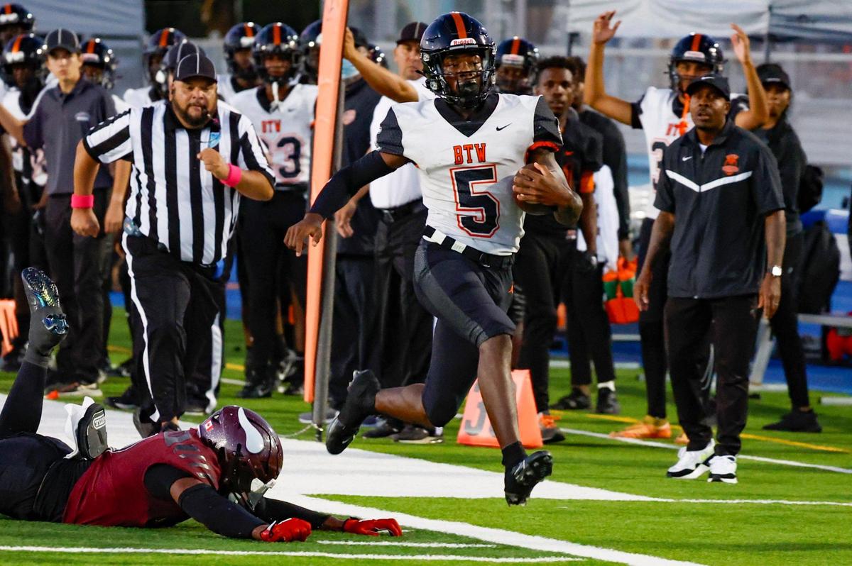 Booker T. Washington High quarterback Claudell Sherman (5) earns a first down on a run against Miami Norland High in the first half at Traz Powell Stadium in Miami on Thursday, October 5, 2023.