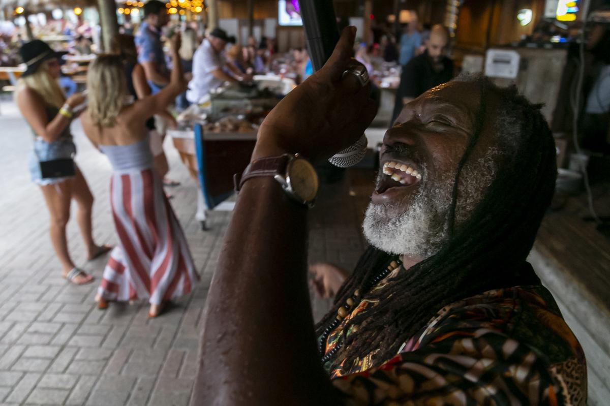 A singer and his band perform live for guests at Monty’s in Coconut Grove.