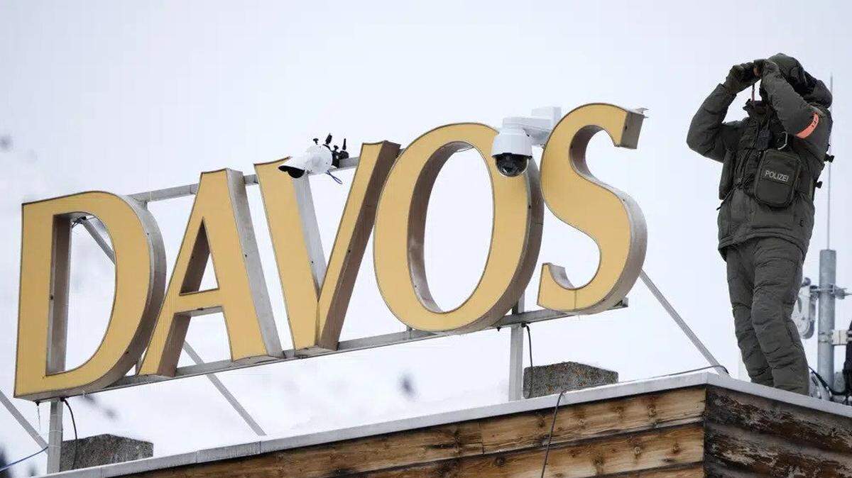 A police officer on a hotel roof monitors the area in Davos, Switzerland where the annual meeting of the World Economic Forum is taking place.