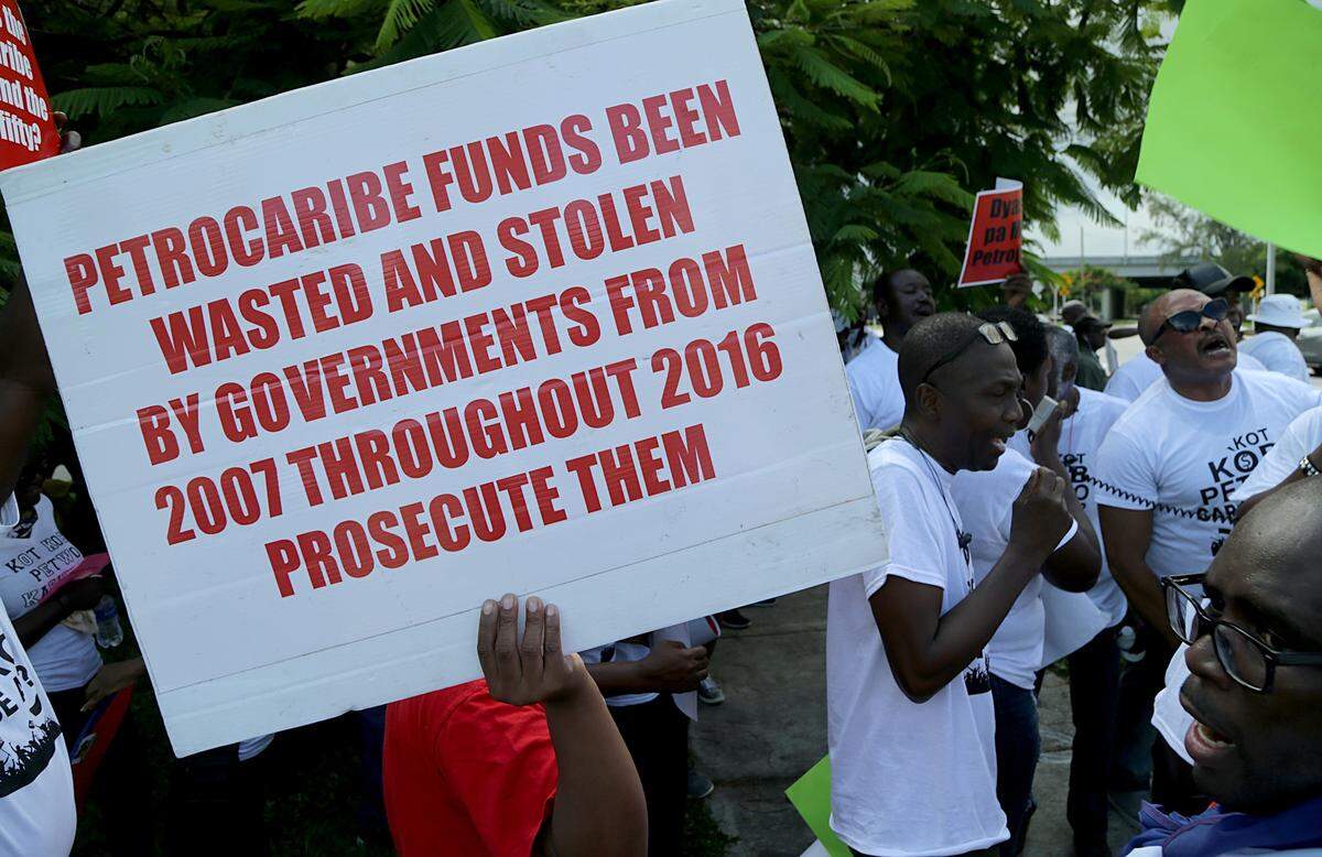 Members of the South Florida Haitian community demonstrate in front of the Haitian consulate in Miami.