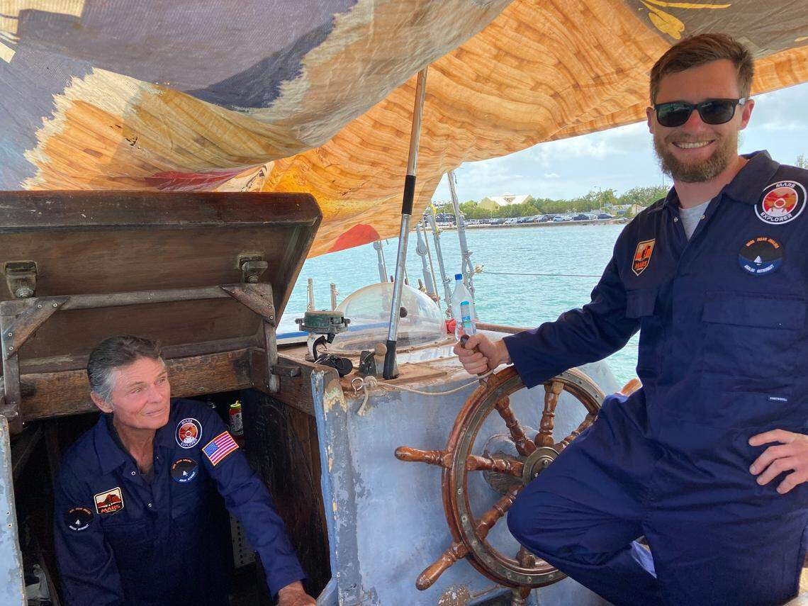 Reid Stowe, a North Carolina-based artist and sailor, comes out from below the deck of the Anne, his 70-foot schooner, while the captain, John Wolfe stands behind the wheel Thursday, March 25, 2021. 