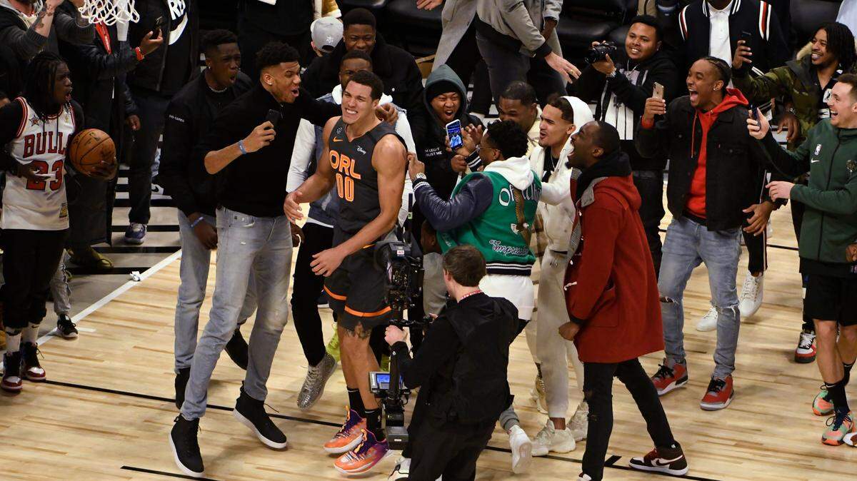 People gather around Orlando Magic’s Aaron Gordon during basketball’s NBA All-Star slam dunk contest Saturday, Feb. 15, 2020, in Chicago.