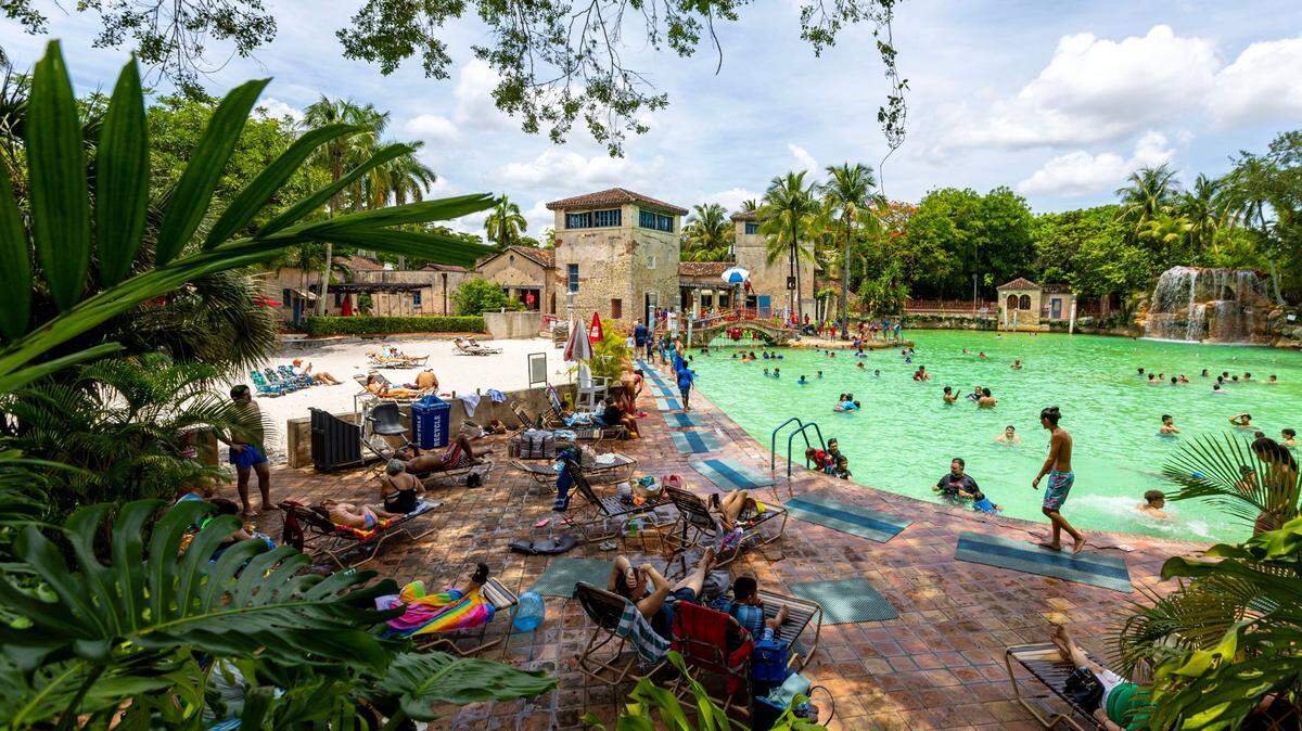 People socialize and swim at Venetian Pool on Wednesday, June 28, 2023, in Coral Gables, Florida. South Florida’s heat can increase the risks of heat exhaustion and heat stroke, especially for people taking certain medications.