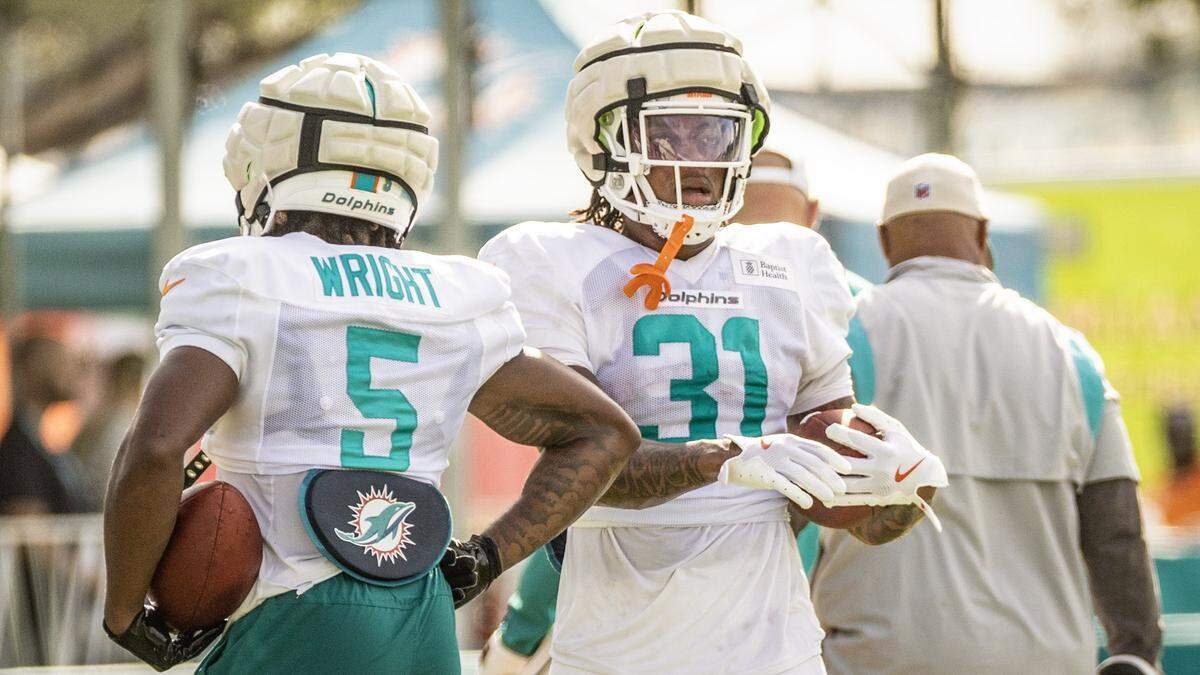 Miami Dolphins running backs Jaylen Wright (5) and Ollie Gordon II (31) run through practice drills.