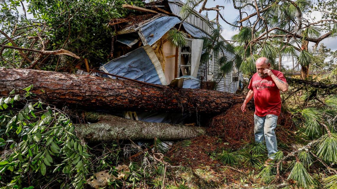 Ron Ganser, 73, inspects the damage to his mobile home caused by a fallen pine tree during Hurricane Idalia in Perry Cove Mobile Home and RV Park in Perry, Florida on Wednesday, August 30, 2023.